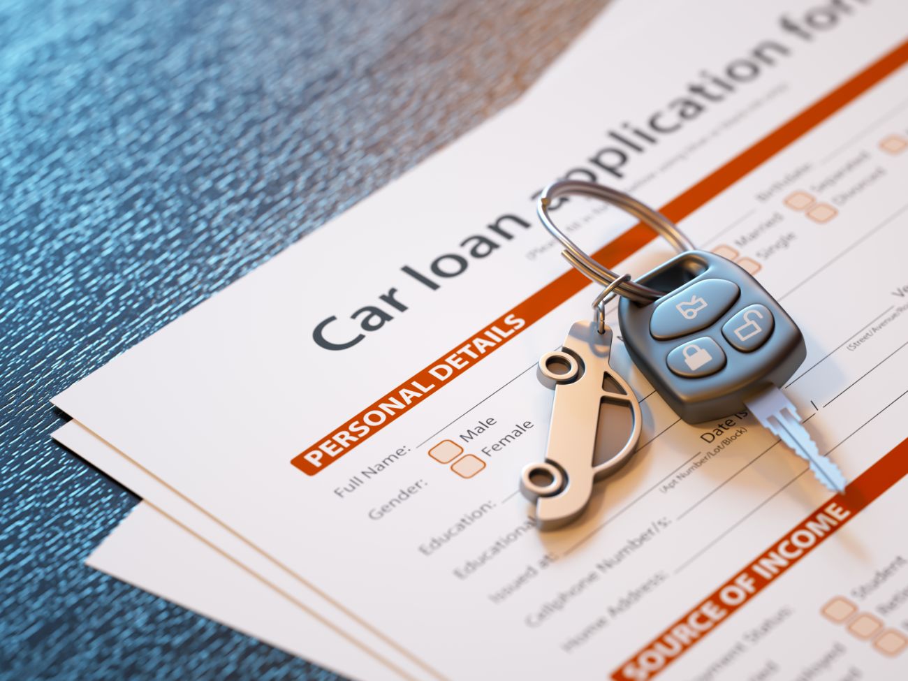 Car loan application with keys sitting on top